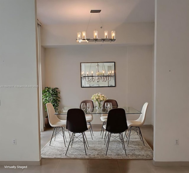 dining space with a chandelier and tile patterned flooring