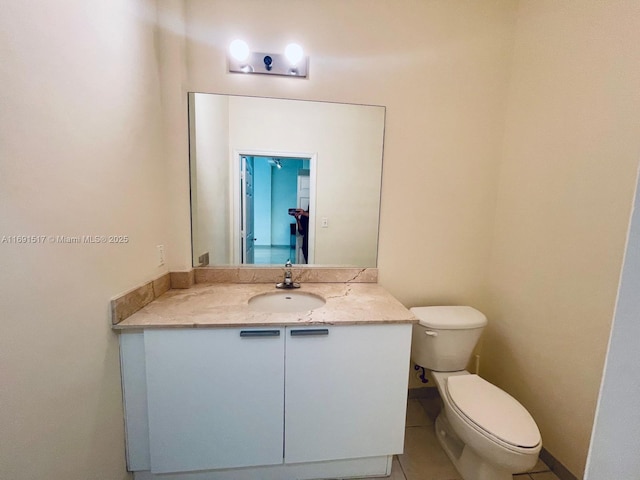 bathroom featuring tile patterned floors, toilet, and vanity