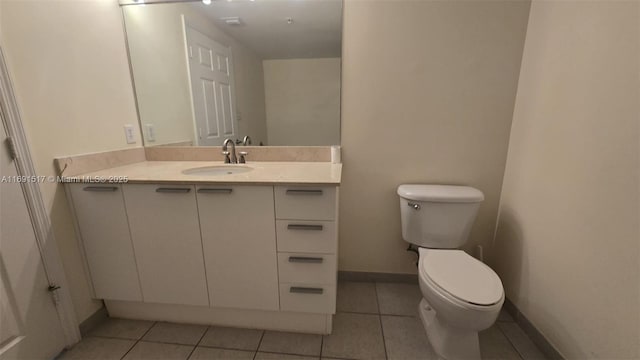 bathroom featuring vanity, tile patterned floors, and toilet