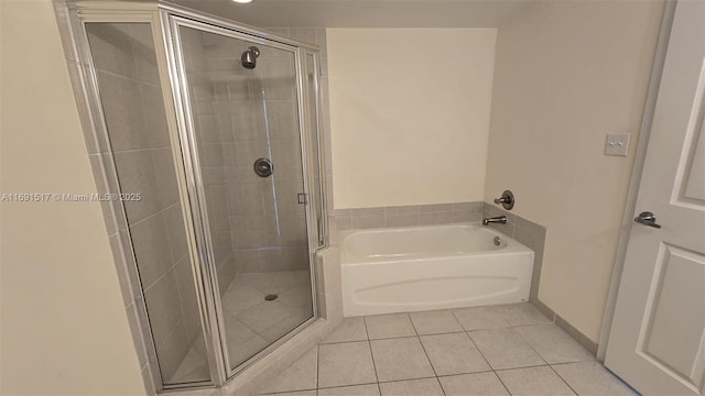 bathroom featuring tile patterned floors and separate shower and tub