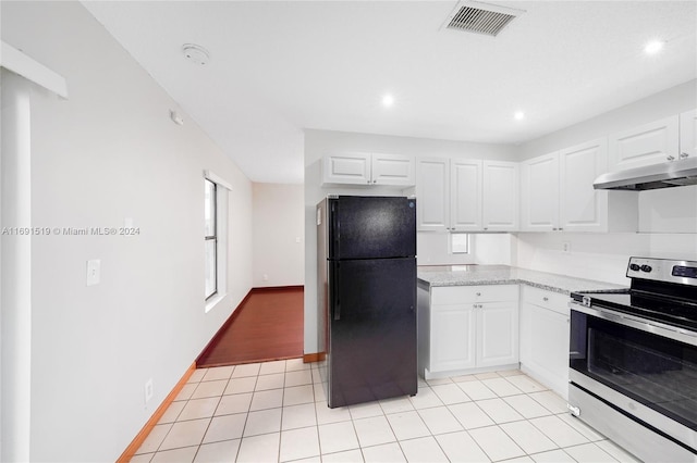 kitchen with black refrigerator, stainless steel range, white cabinets, and light tile patterned floors