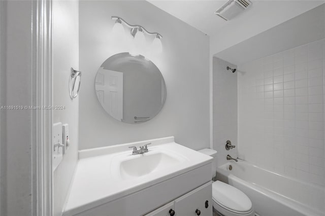 full bathroom with vanity, tiled shower / bath combo, and toilet