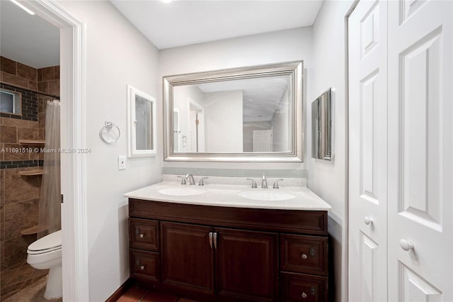 bathroom featuring vanity, toilet, and walk in shower