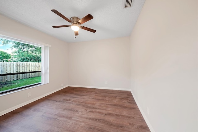 empty room with wood-type flooring, a textured ceiling, and ceiling fan