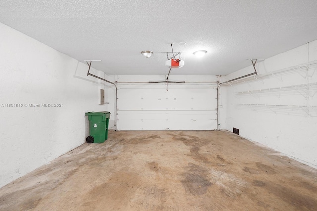 garage featuring electric panel and a garage door opener