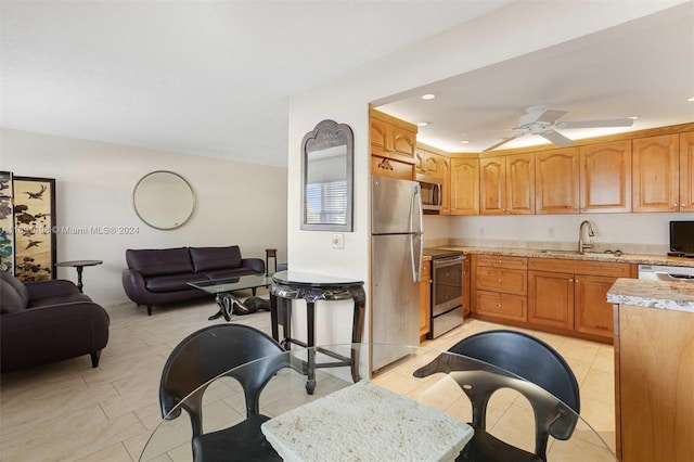 kitchen with light tile patterned flooring, ceiling fan, sink, and appliances with stainless steel finishes