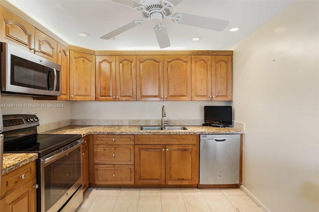 1042 Lincoln C Unit 1042, Boca Raton, FL 33434 - kitchen with stainless steel appliances, a sink, brown cabinetry, light stone countertops, and recessed lighting