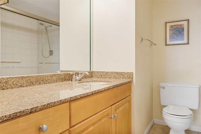 bathroom featuring vanity, walk in shower, tile patterned floors, and toilet