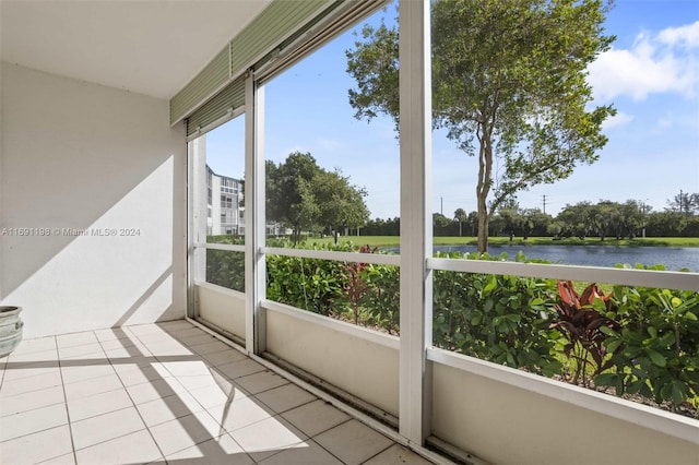 sunroom / solarium with a water view