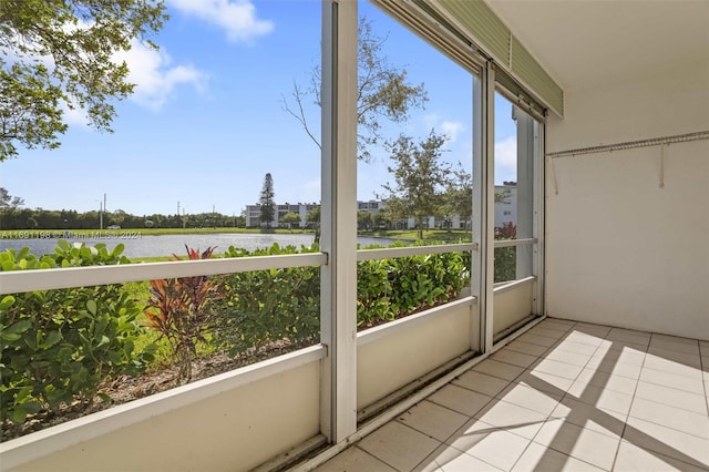 unfurnished sunroom with a water view