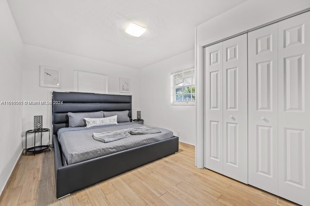 bedroom featuring a closet and light hardwood / wood-style flooring