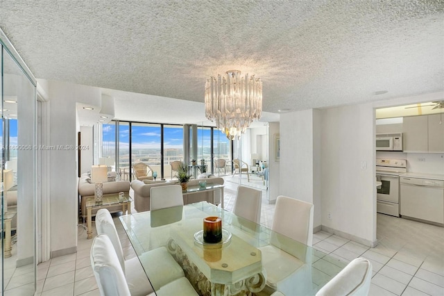 dining area featuring expansive windows, ceiling fan, a textured ceiling, and light tile patterned floors