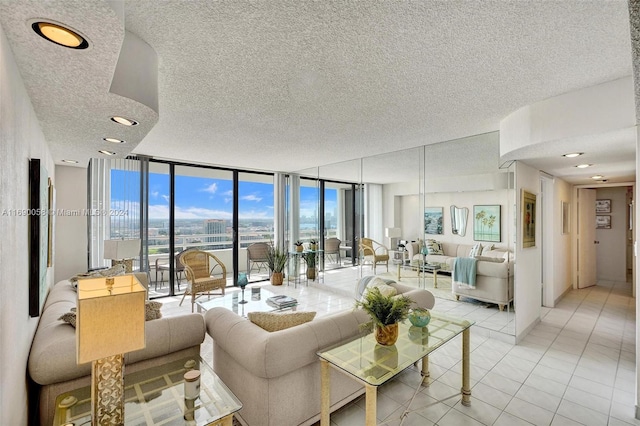 living room with a wall of windows, light tile patterned floors, and a textured ceiling