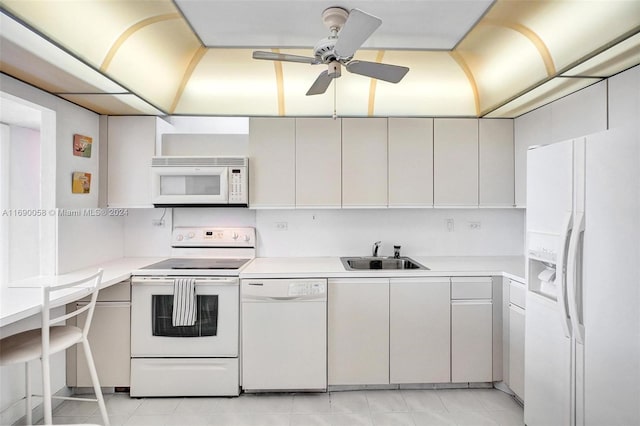 kitchen with light tile patterned floors, white appliances, ceiling fan, and sink