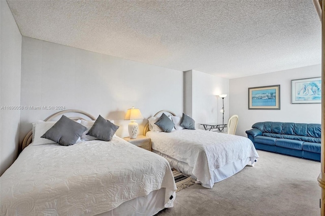 carpeted bedroom featuring a textured ceiling