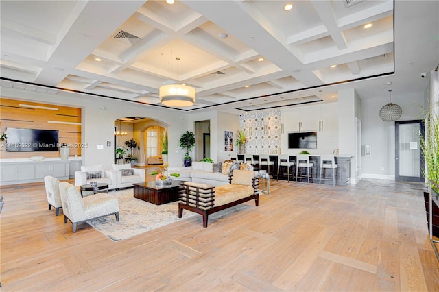 living room featuring beam ceiling, light hardwood / wood-style flooring, and coffered ceiling