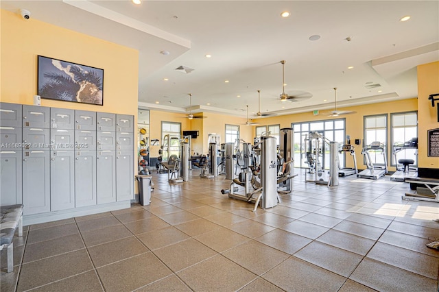 gym featuring ceiling fan and a raised ceiling