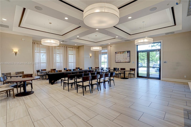 dining space featuring a healthy amount of sunlight, french doors, and a tray ceiling