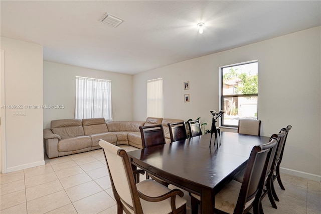 dining space featuring light tile patterned floors