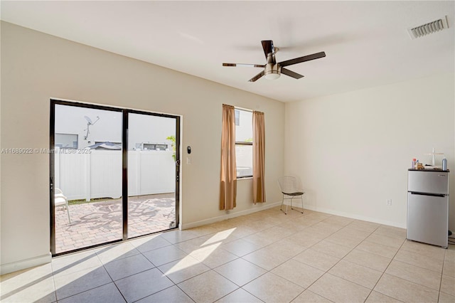 spare room with light tile patterned floors and ceiling fan