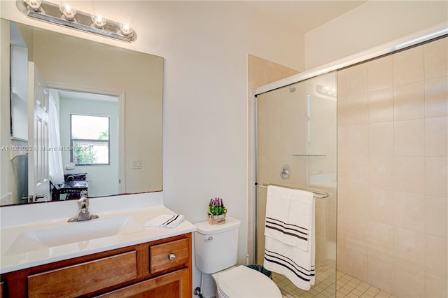 bathroom with vanity, an enclosed shower, and toilet