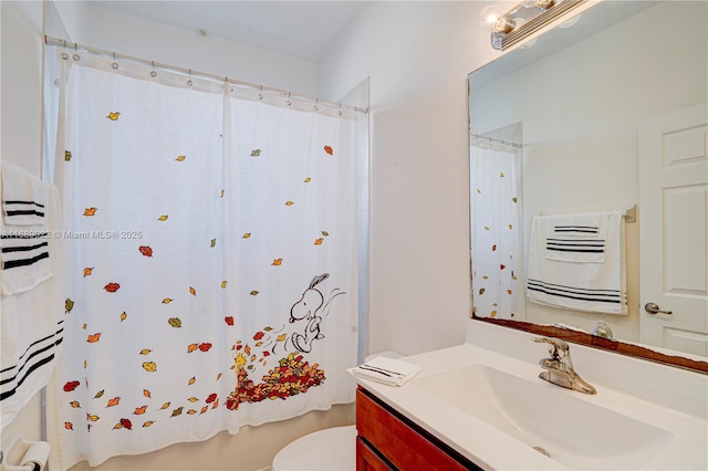 bathroom featuring vanity and toilet