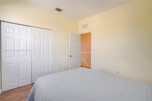 carpeted bedroom featuring a closet