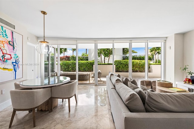 living room with floor to ceiling windows and plenty of natural light