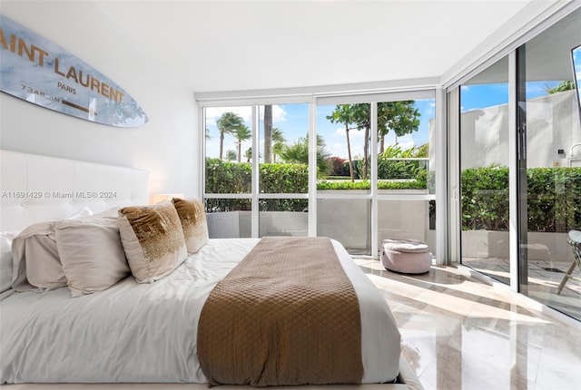 bedroom with expansive windows and access to outside