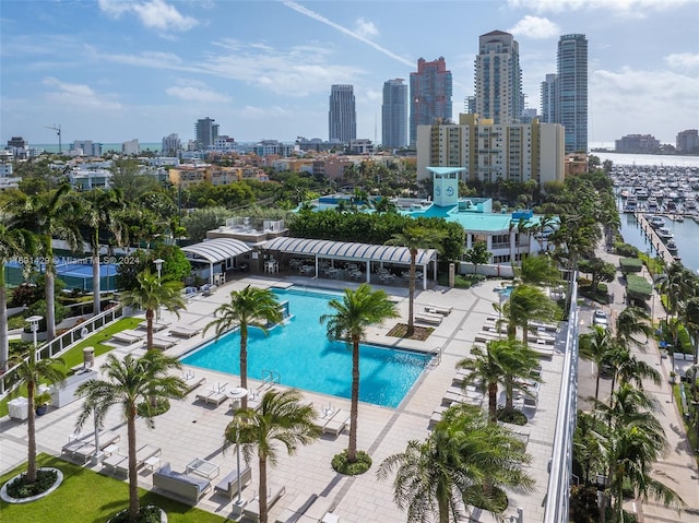 view of swimming pool featuring a water view and a patio