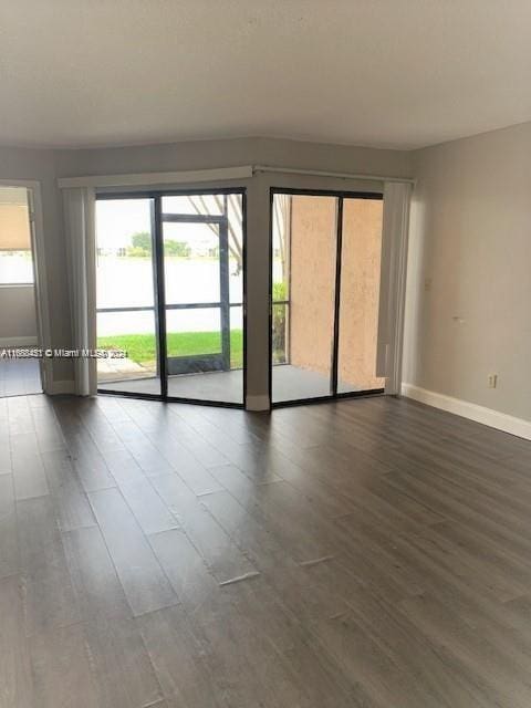 empty room featuring dark wood-type flooring