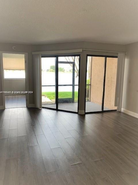 unfurnished room featuring dark hardwood / wood-style floors