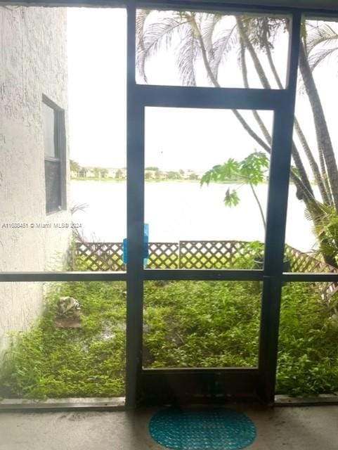 entryway with concrete floors and a water view