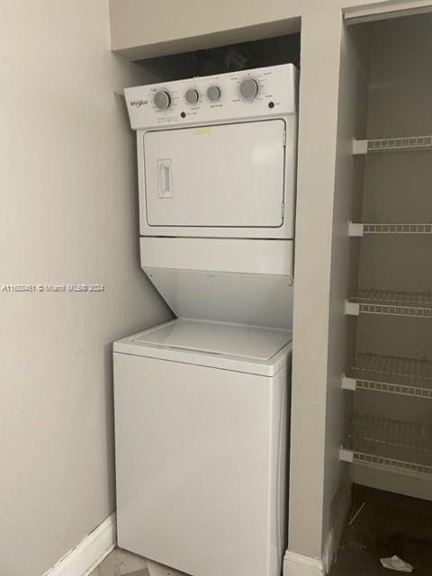 washroom with stacked washer and clothes dryer