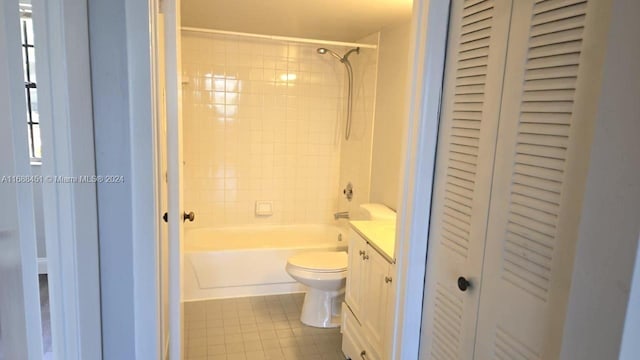 full bathroom with vanity, tile patterned floors, toilet, and tiled shower / bath