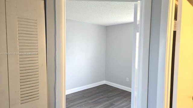 bathroom featuring wood-type flooring and a textured ceiling