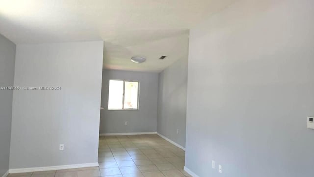 empty room with light tile patterned floors