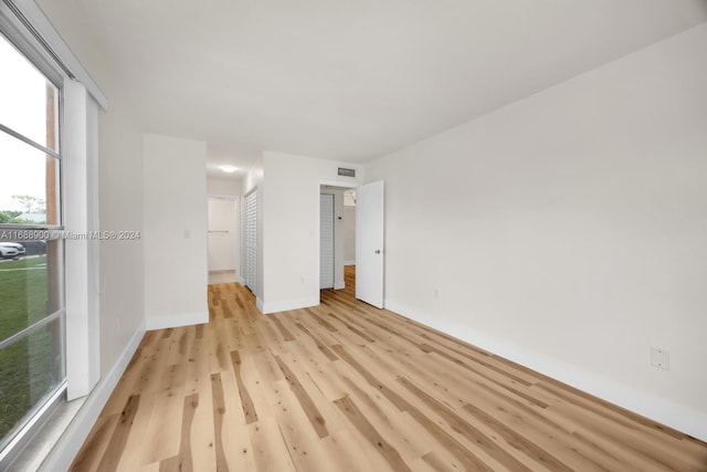 spare room featuring light hardwood / wood-style flooring