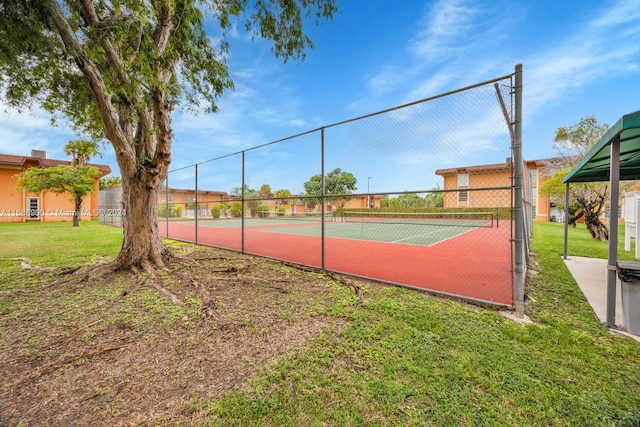 view of sport court with a yard