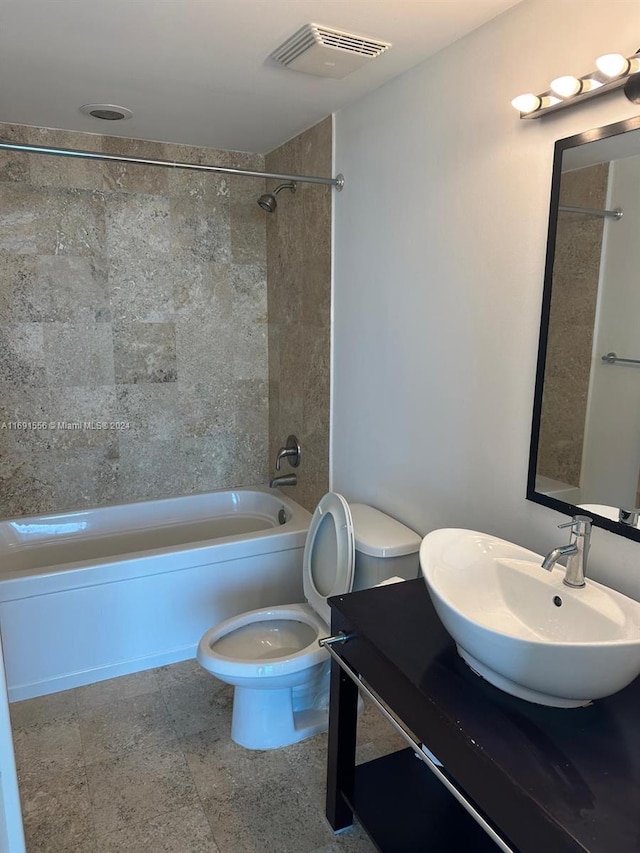 full bathroom featuring vanity, toilet, and tiled shower / bath