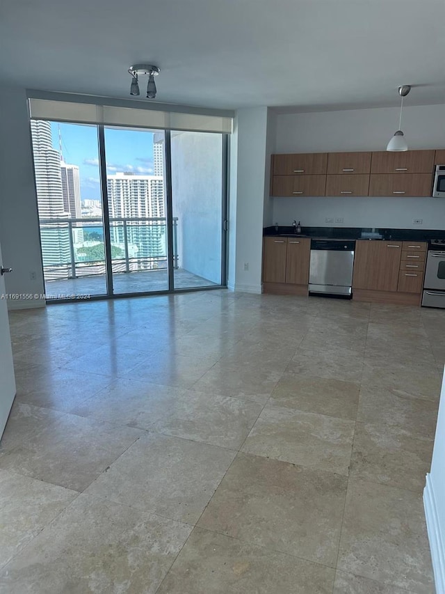 kitchen featuring appliances with stainless steel finishes, decorative light fixtures, and sink