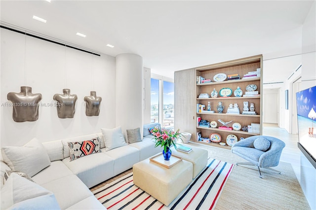 living room with light hardwood / wood-style floors and floor to ceiling windows