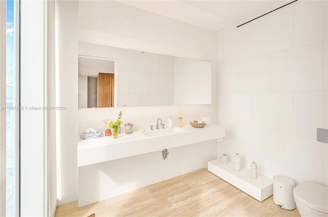 9111 Collins Ave Unit N-Ph6, Surfside, FL 33154 - bathroom featuring a sink, toilet, tile walls, a garden tub, and wood finished floors
