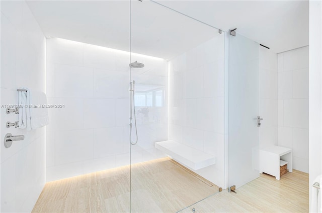 bathroom featuring tile walls and tiled shower