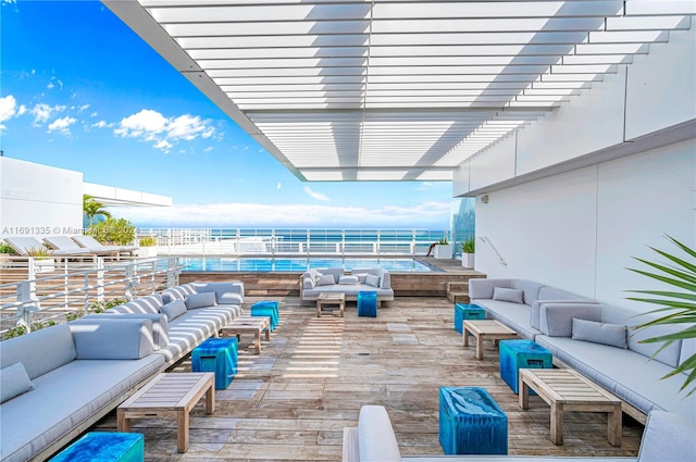 view of patio / terrace with outdoor lounge area, a water view, and a pergola