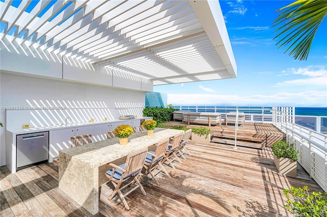 wooden deck featuring a water view and a pergola