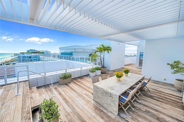 9111 Collins Ave Unit N-Ph6, Surfside, FL 33154 - wooden terrace with a water view and outdoor dining area