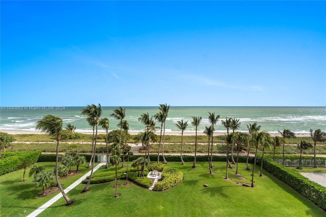 surrounding community featuring a water view, a lawn, and a beach view