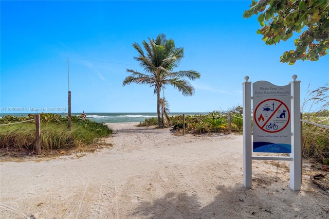 surrounding community with a beach view and a water view