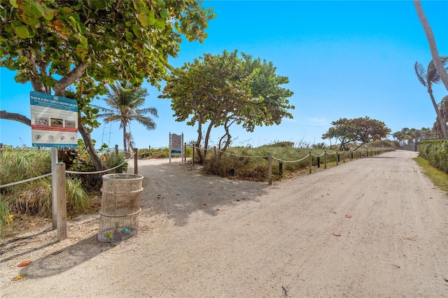 8855 Collins Ave Unit 5A, Surfside, FL 33154 - view of dirt / gravel driveway with a gated entry